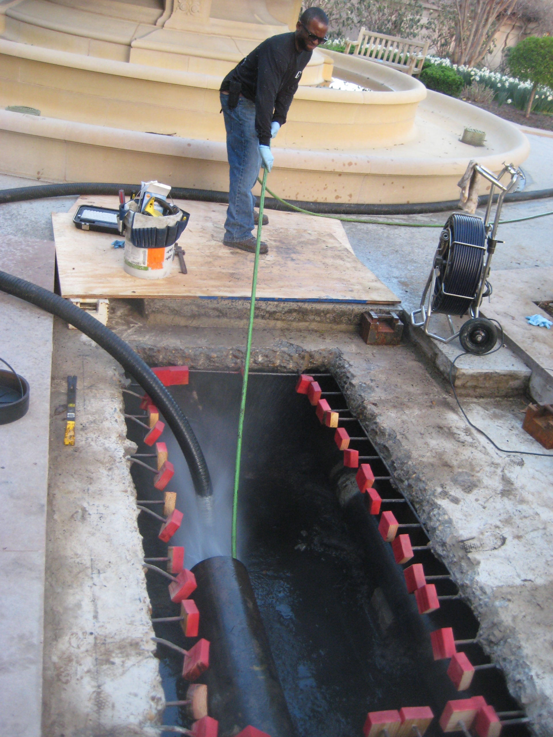 a worker cleaning out a sewer line